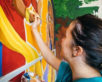 Childcare volunteer painting in Delhi India with IVHQ
