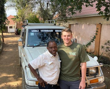 An IVHQ animal care volunteer with the local vet in Tanzania